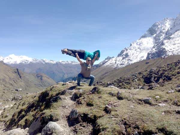 Trekker resting on a boulder high on the Salkantay trail